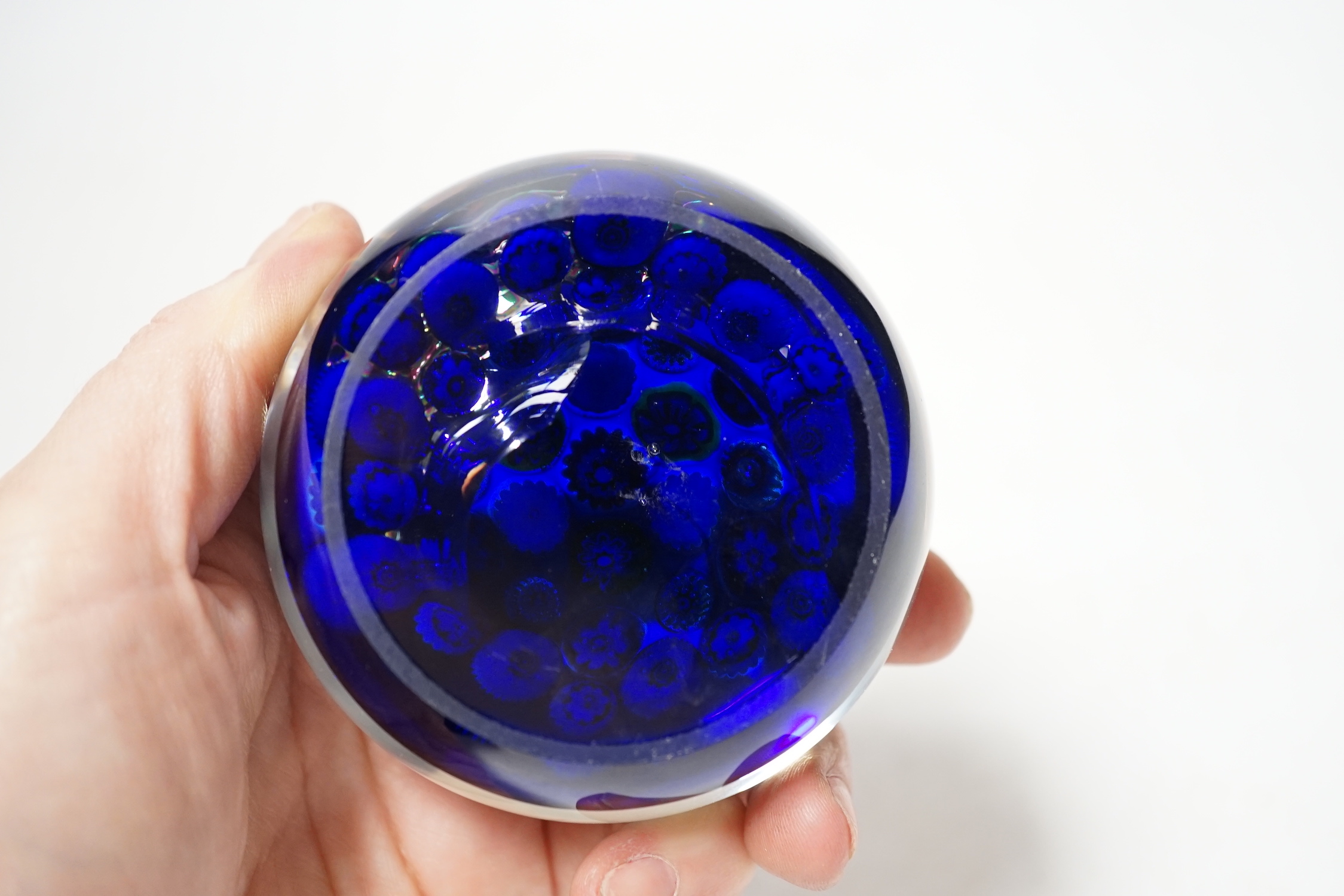 A Clichy translucent blue ground millefiori glass paperweight, 7cm in diameter